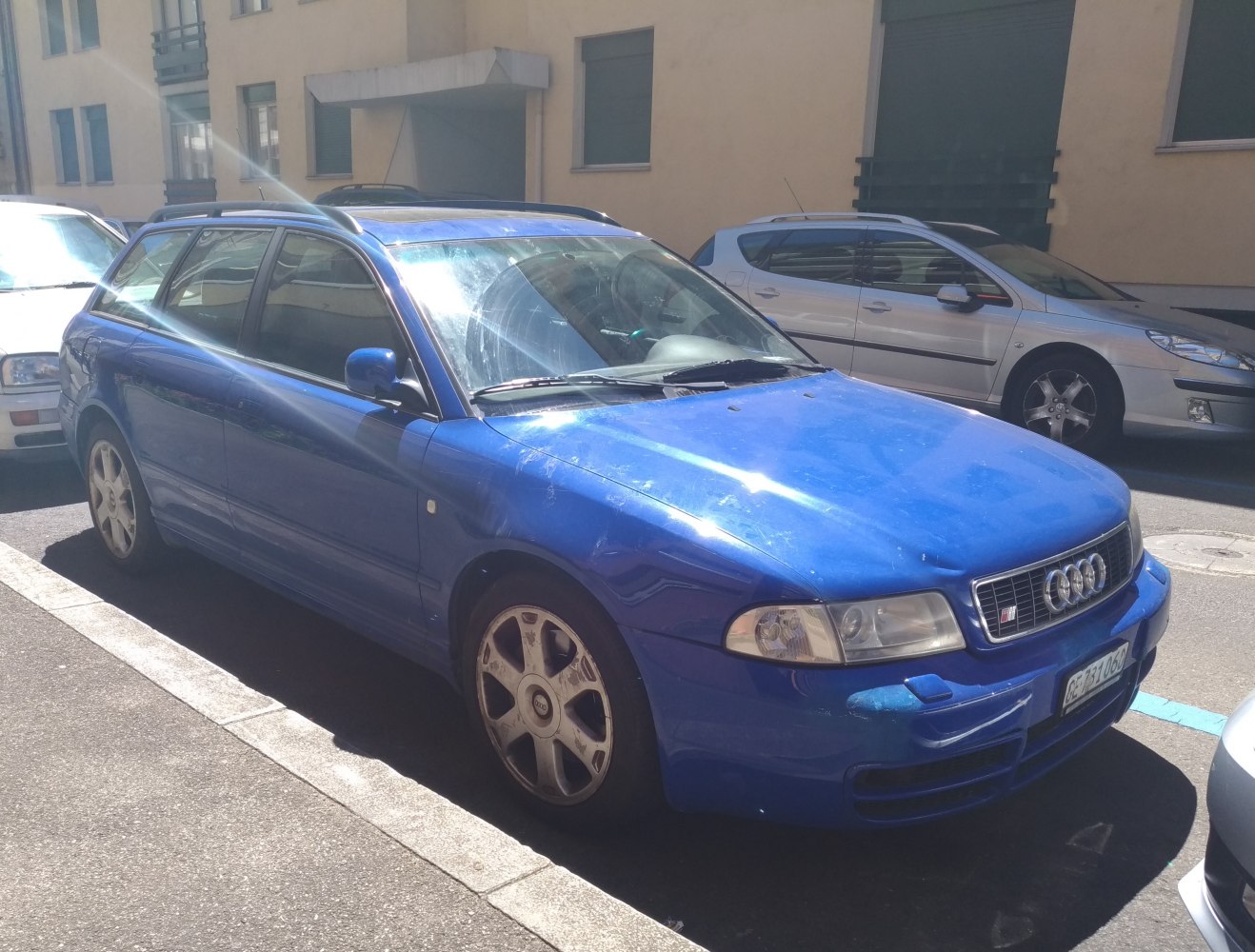 Blue station wagon front-side exterior with alloy wheels