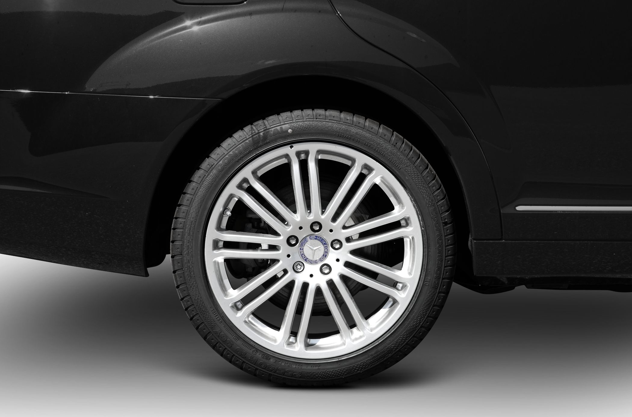 Close-up of multi-spoke alloy wheel and tire on a luxury sedan.