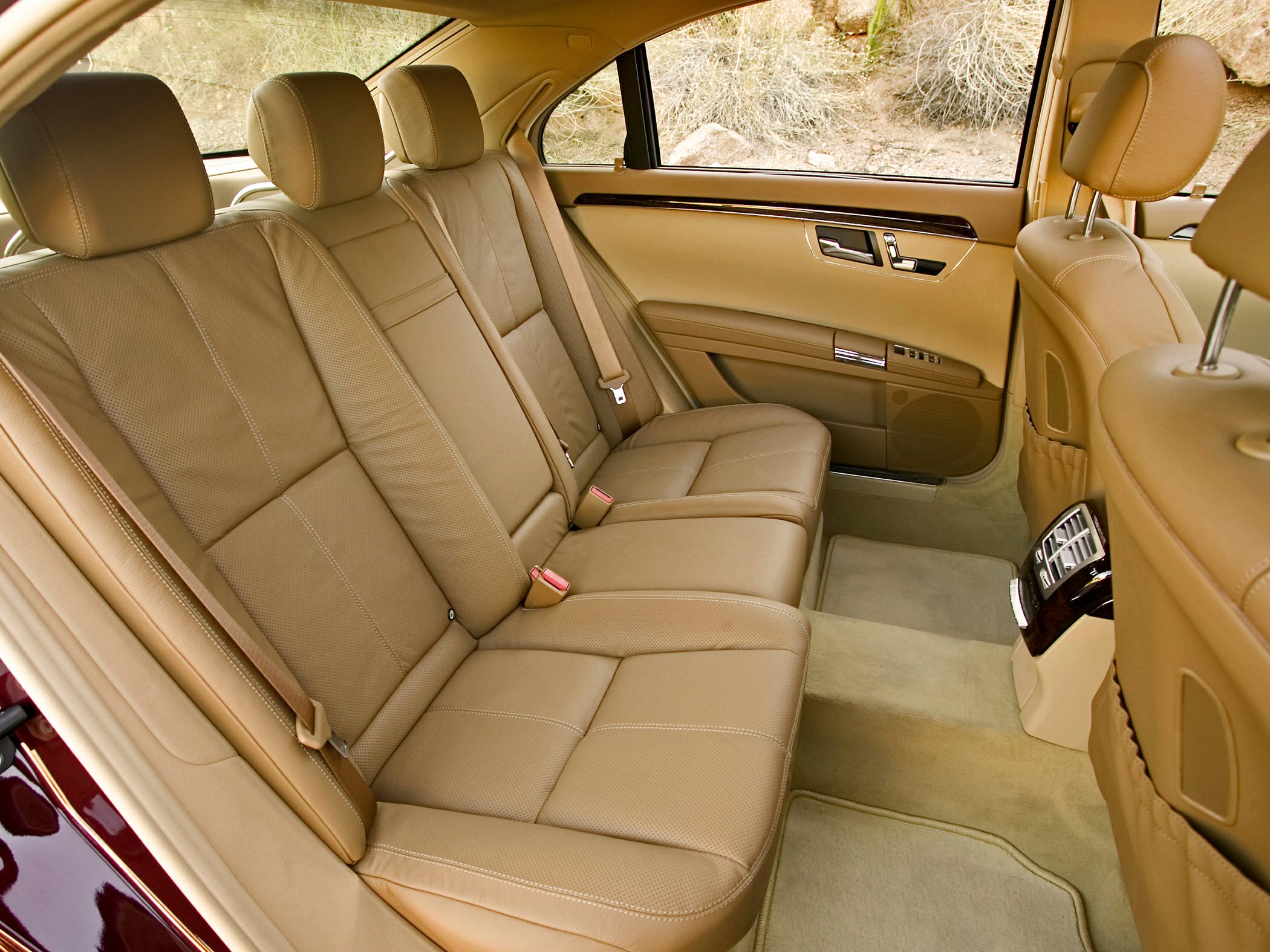 Beige leather rear seats with wood trim and rear climate control panel