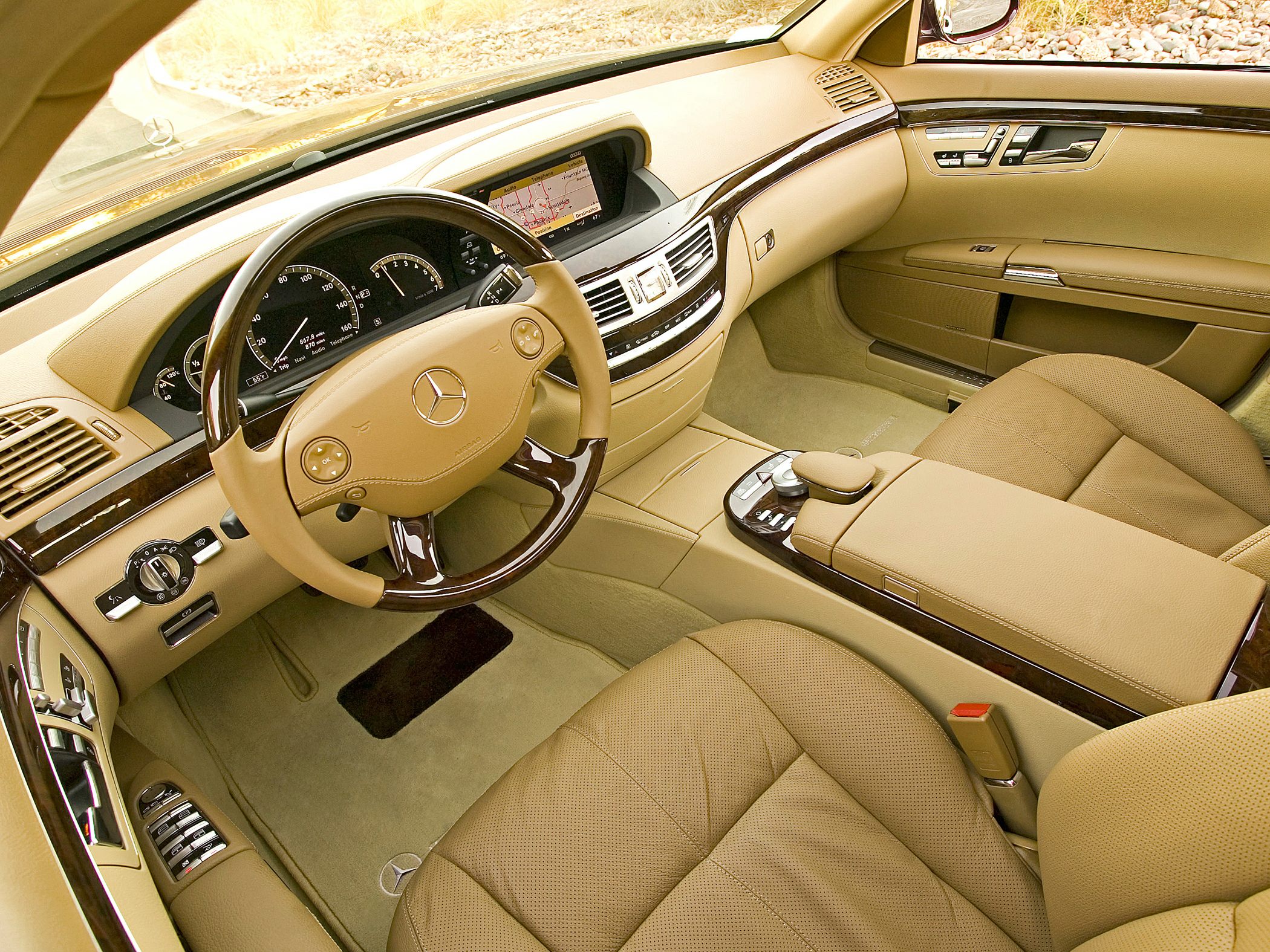 Beige leather interior with wood trim and digital display