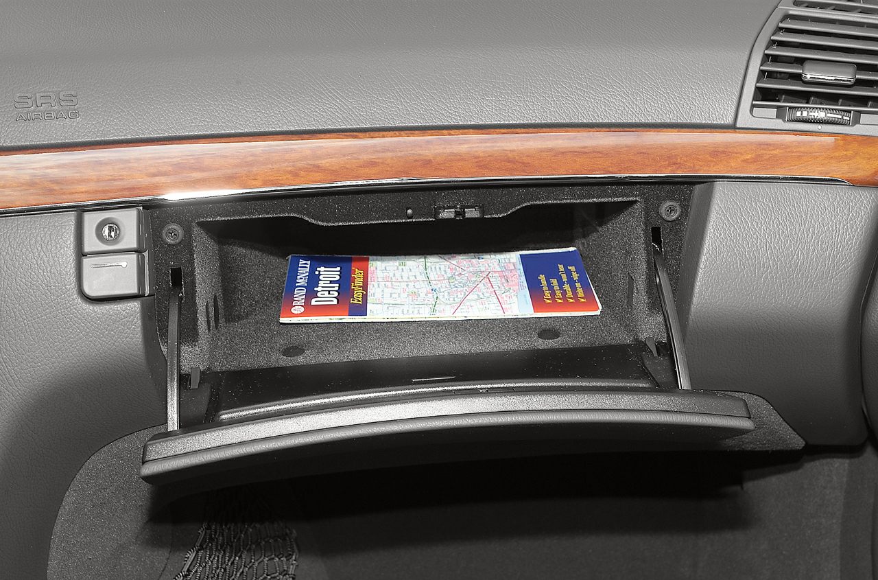 Open glove box with wood trim and dashboard details