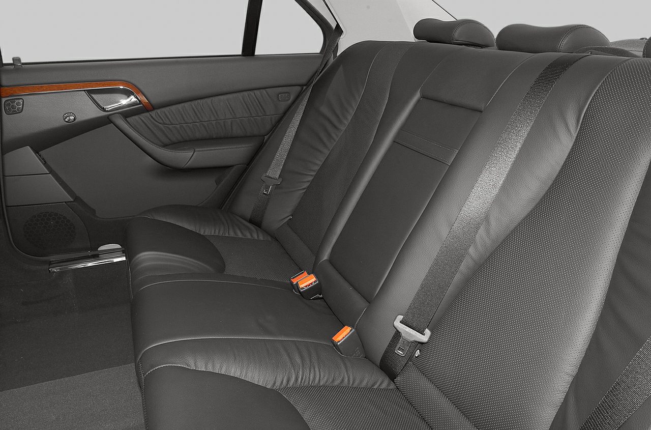 Rear black leather seats and door panel interior with seat belts