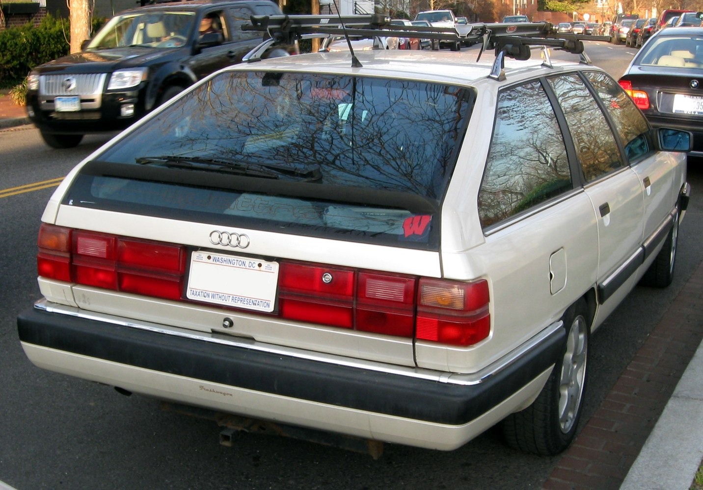 Rear view of 1980s station wagon with roof rack and distinctive taillights