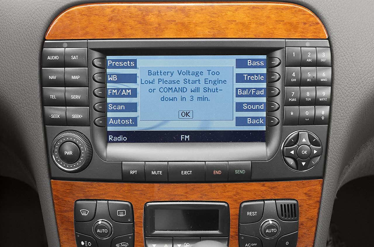 COMAND system interface with control buttons and wood trim