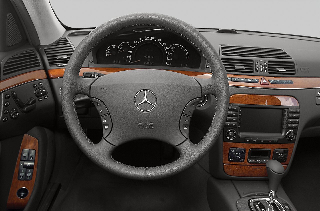 Luxury steering wheel and wood-trimmed dashboard with controls