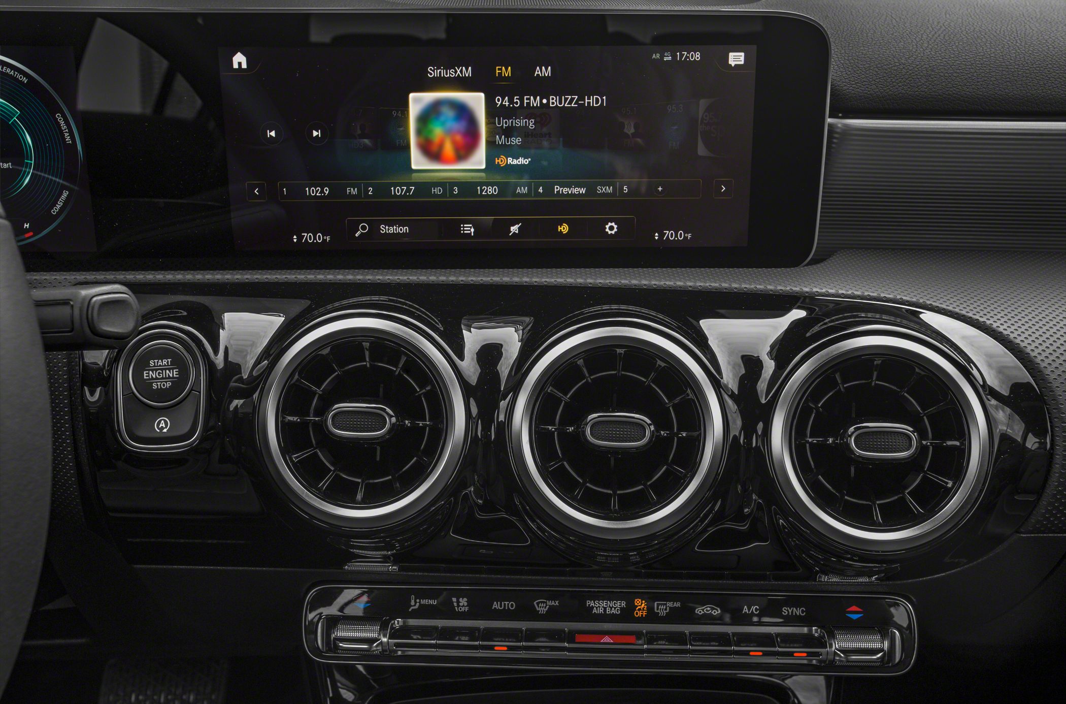 Digital infotainment display and triple circular air vents with start/stop button