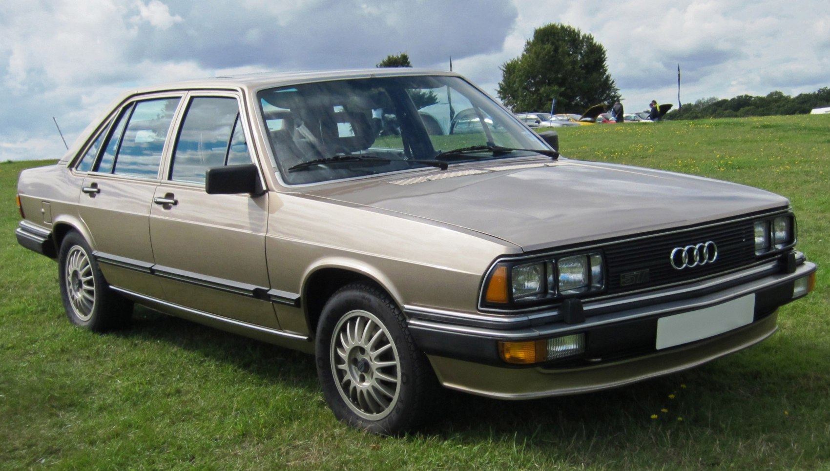 Front side view of classic sedan with rectangular headlights and alloy wheels