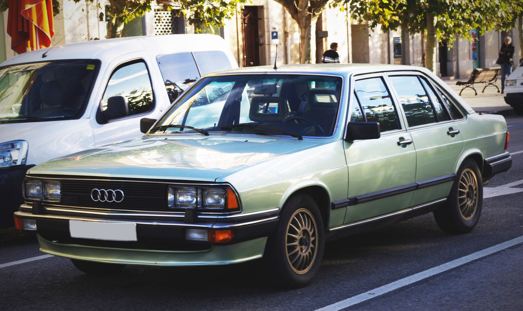 Front angled view of classic 1980s sedan with rectangular headlights and alloy wheels