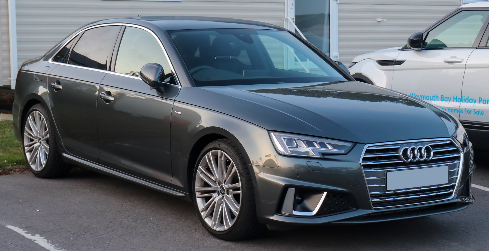 Front side view of a sleek sedan with LED headlights and alloy wheels