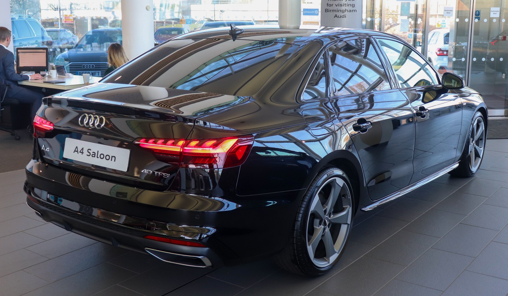 Rear and side view with illuminated LED tail lights and alloy wheels on saloon.