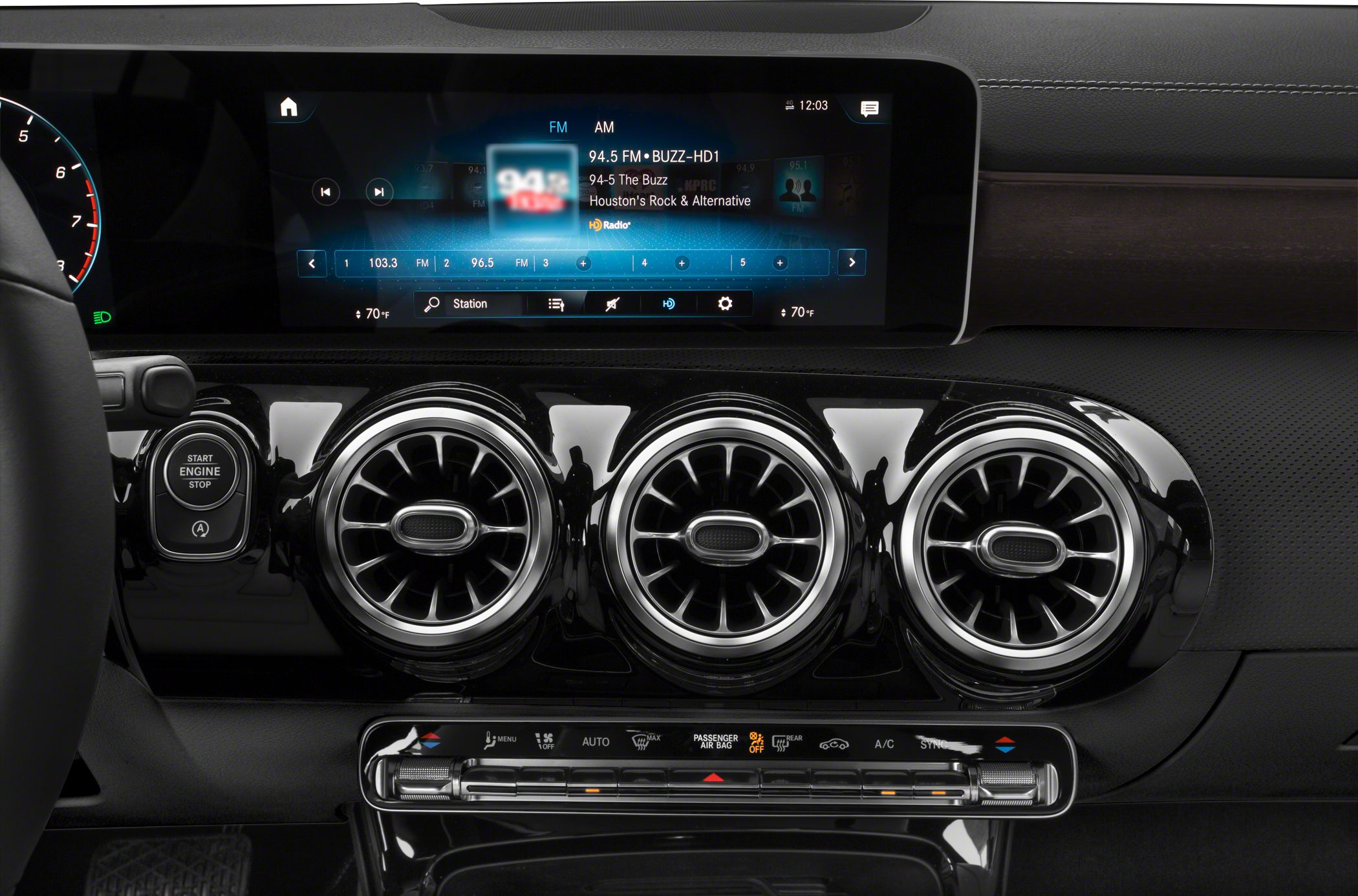 Turbine-style air vents and digital infotainment screen in luxury car interior