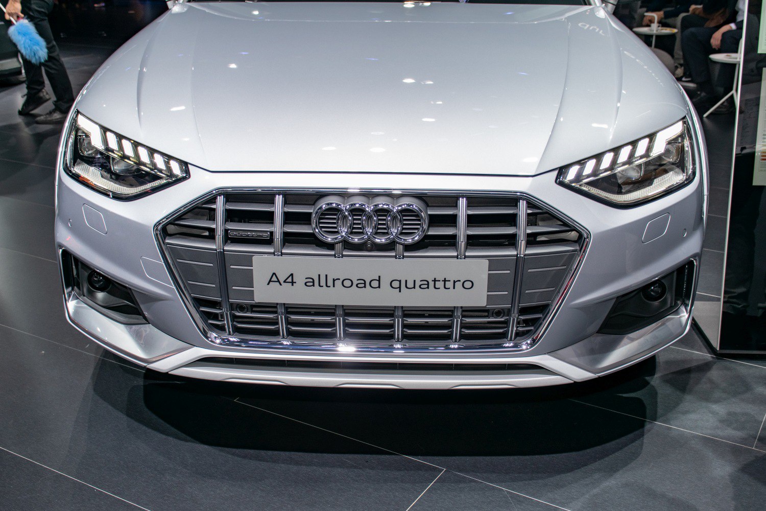 Close-up of front grille with chrome slats and LED headlights