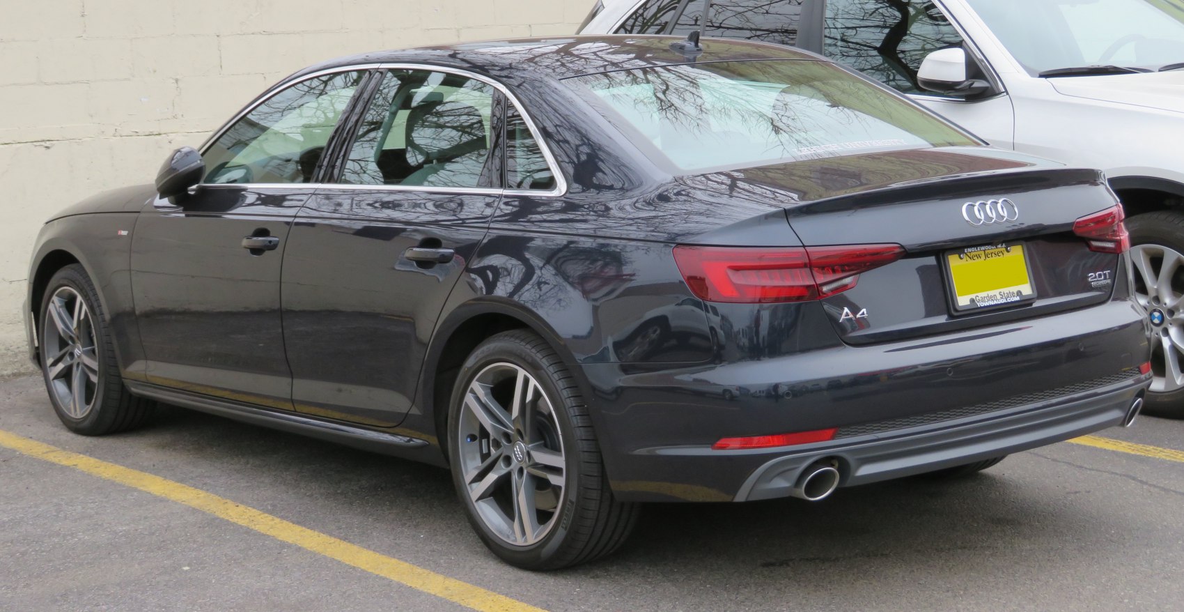 Rear view with taillights, 20T badge, dual exhaust, and alloy wheels