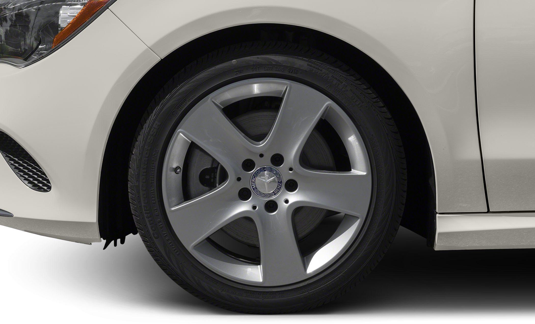 Close-up of a 5-spoke alloy wheel and tire on a facelifted coupe.