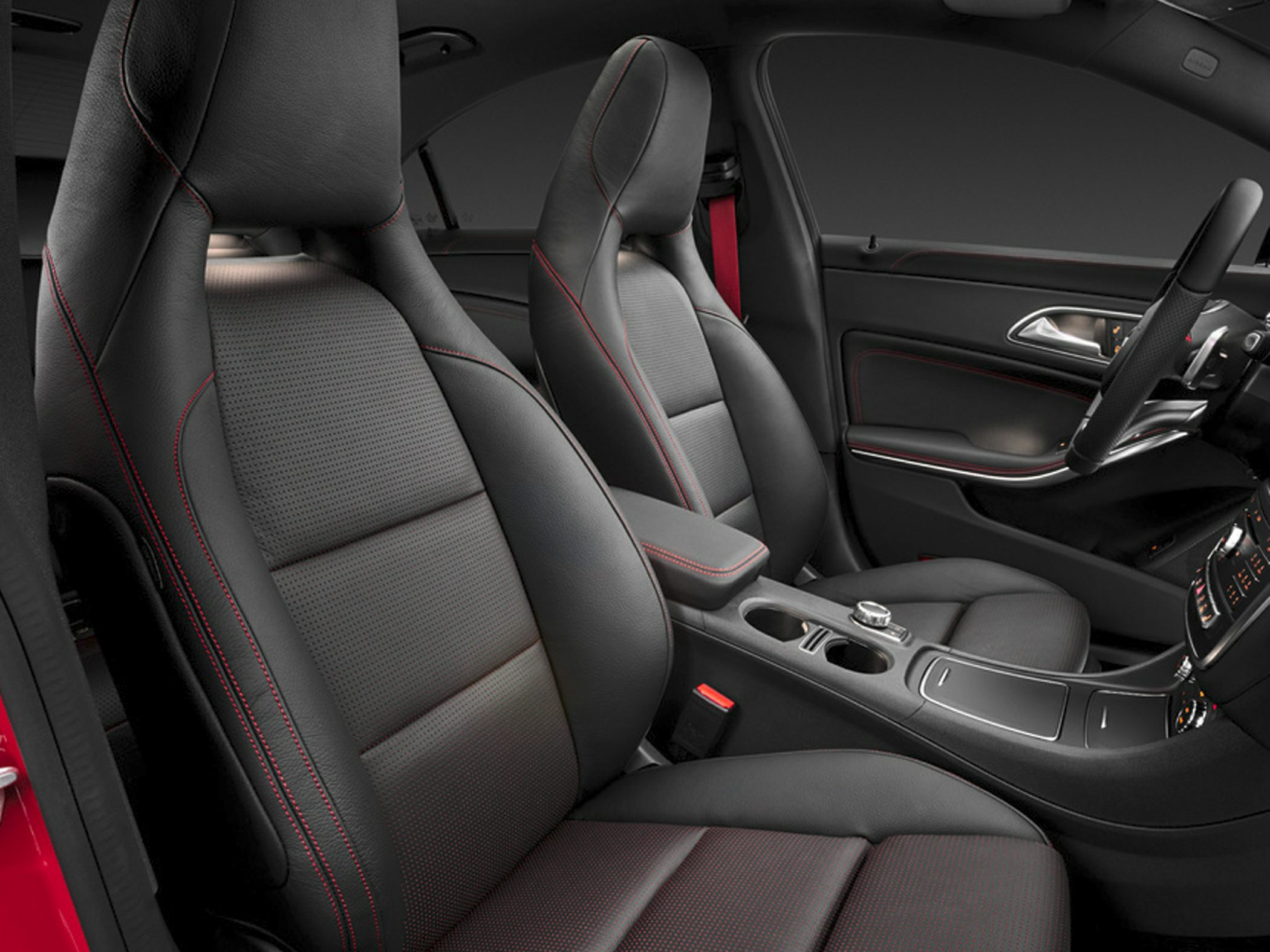 Black leather sport seats with red contrast stitching and central console view