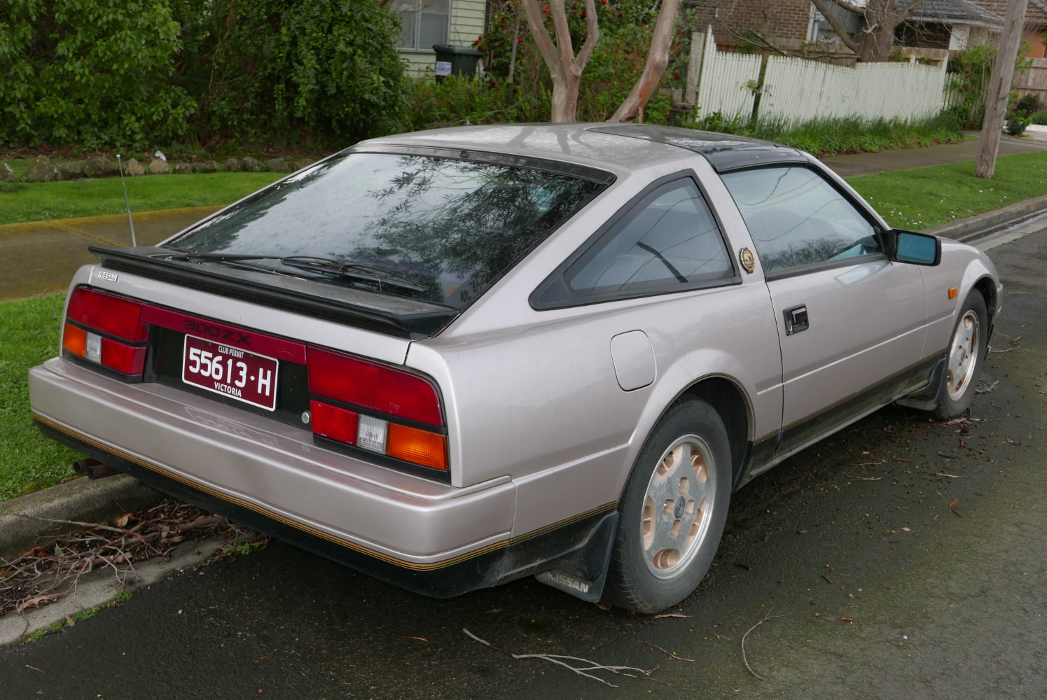 Rear and side view of angular hatchback with vintage alloy wheels