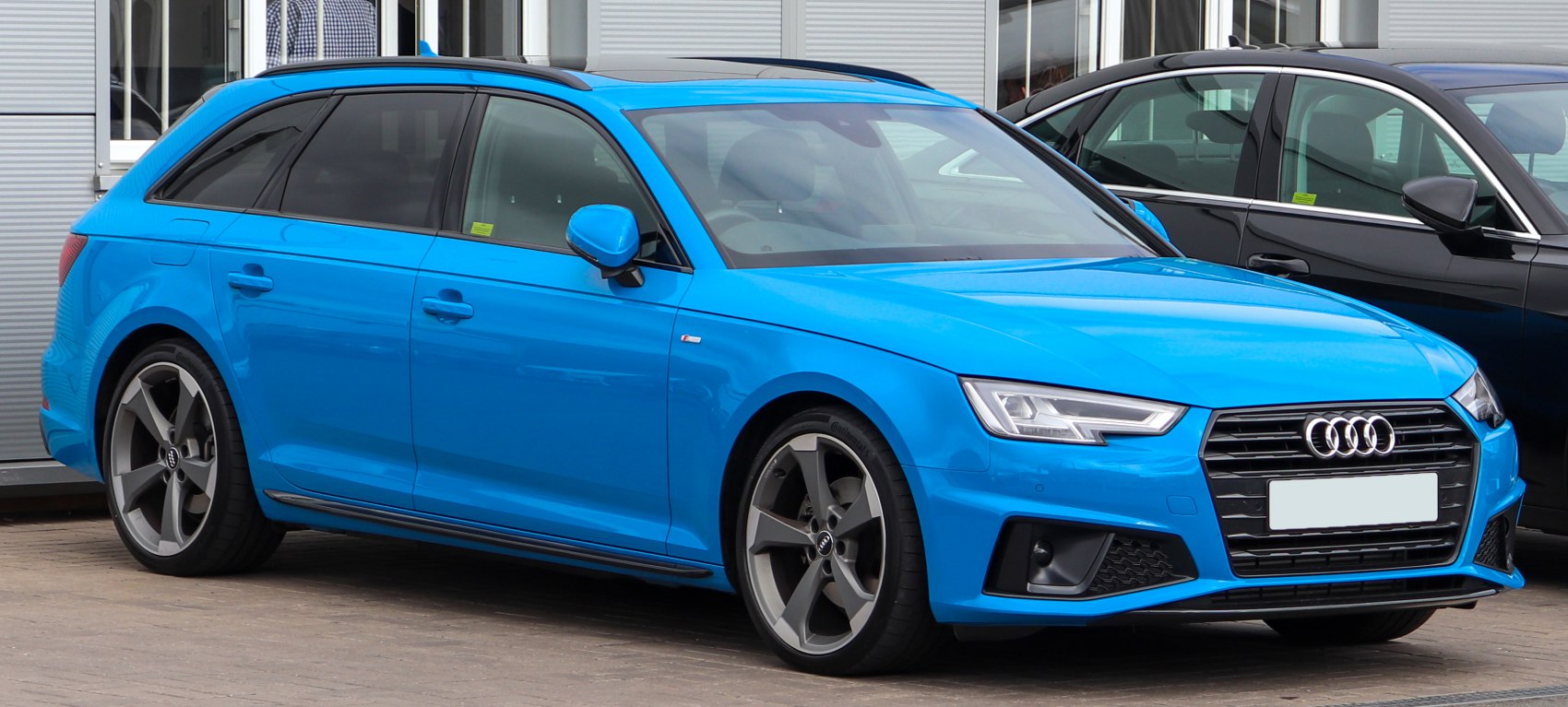 Bright blue station wagon with LED headlights and alloy wheels