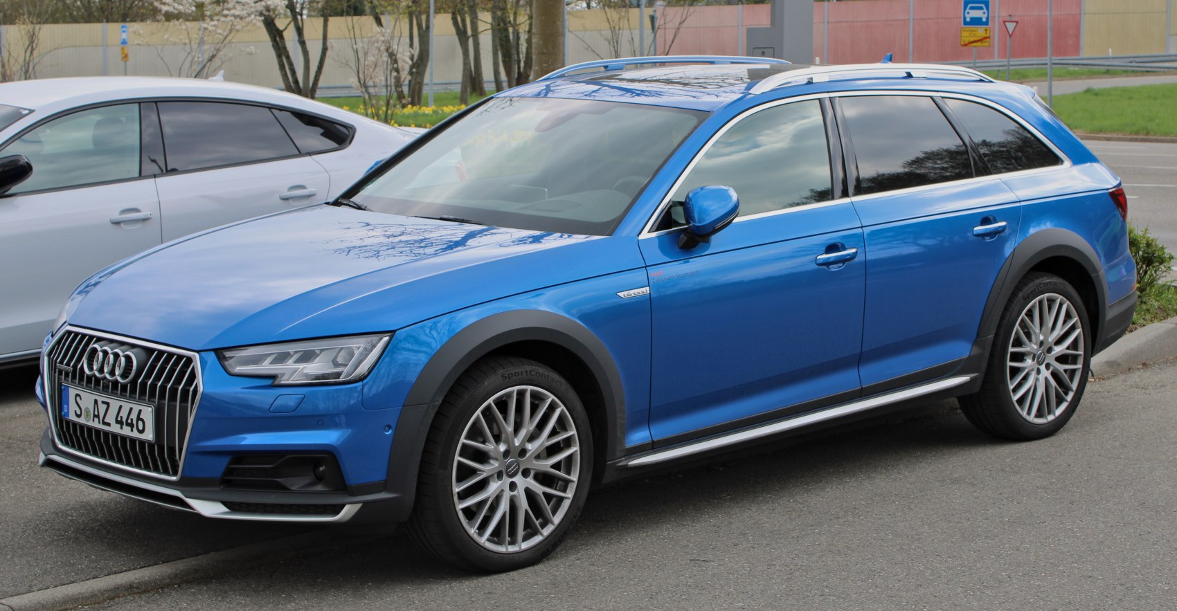 Blue vehicle with black wheel arch cladding and silver roof rails