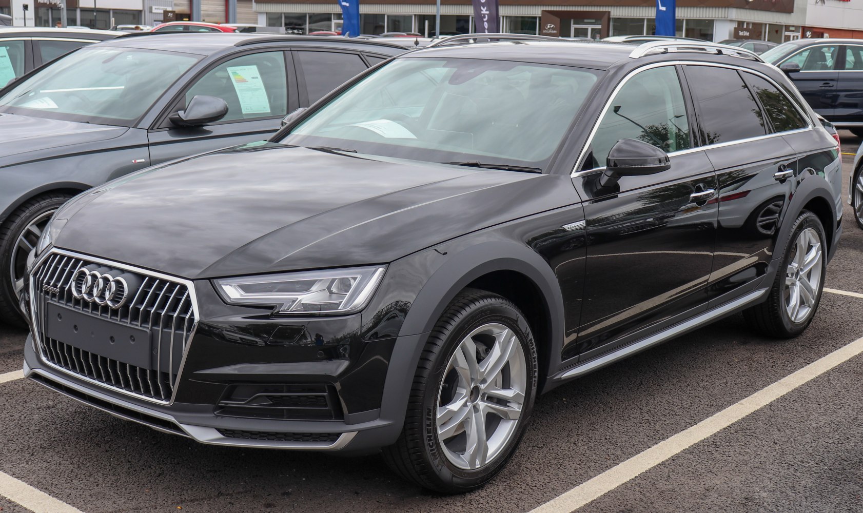 Front and side view of a luxury crossover with alloy wheels and roof rails