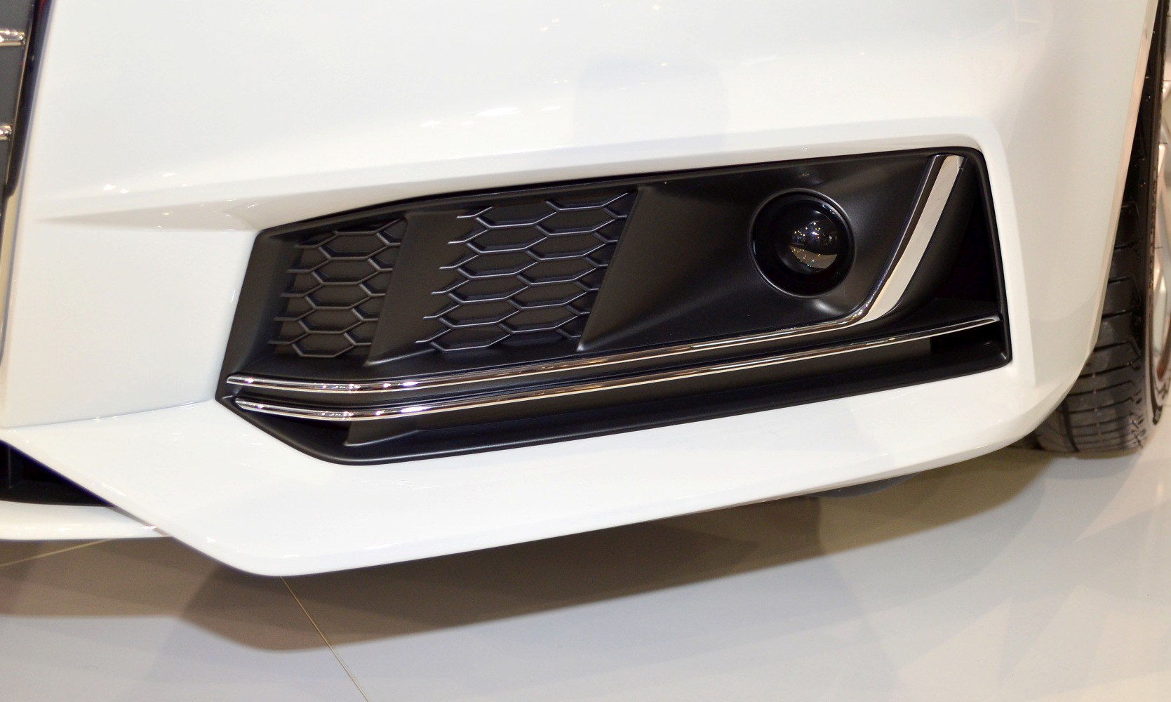 Close-up of front fog light and honeycomb grille