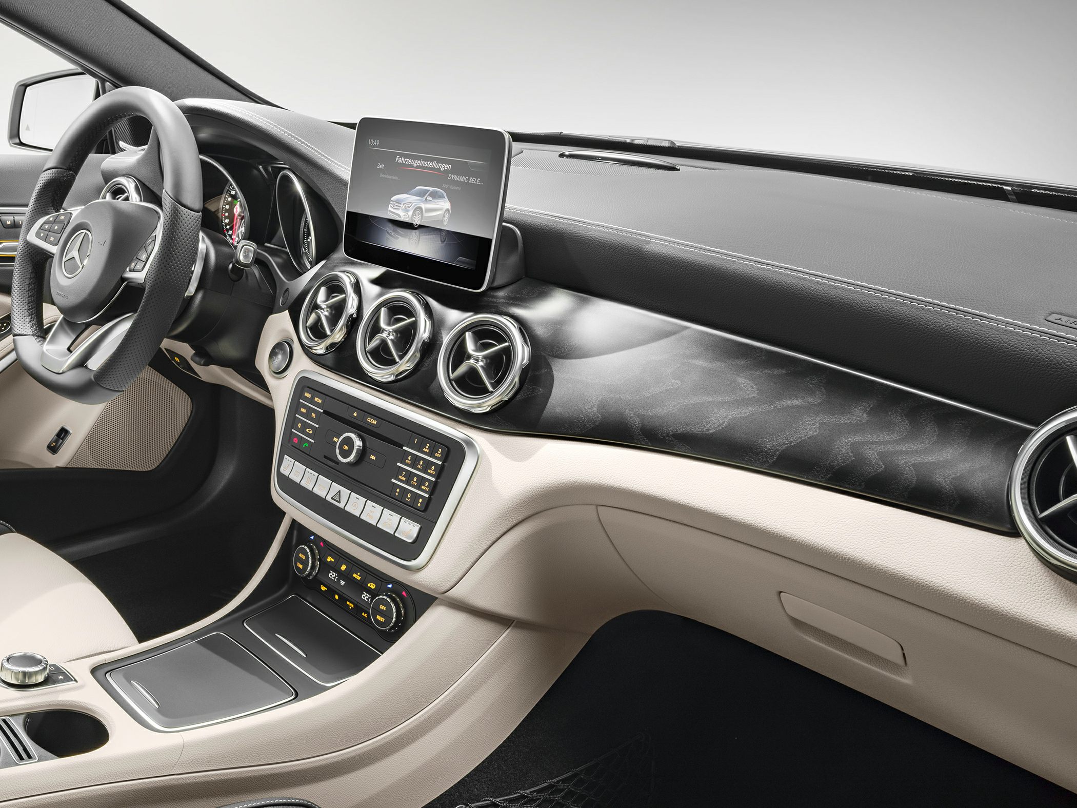 Dashboard with infotainment display and circular air vents in luxury car interior