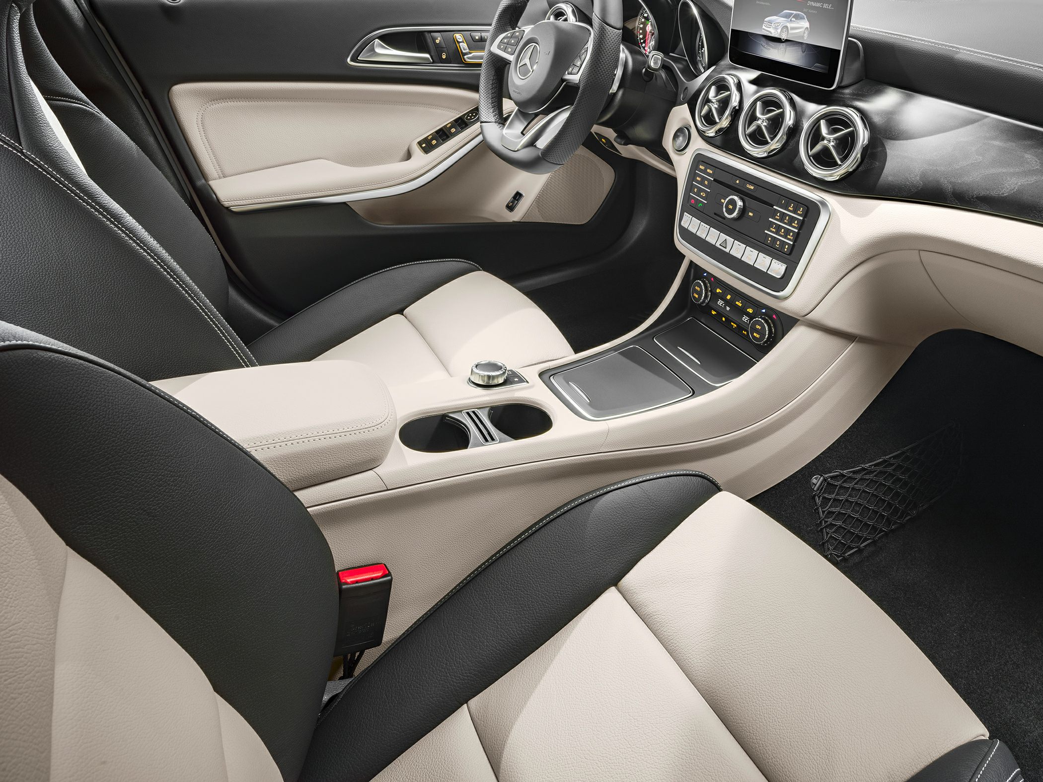Compact SUV interior with beige-black leather seats and modern circular air vents