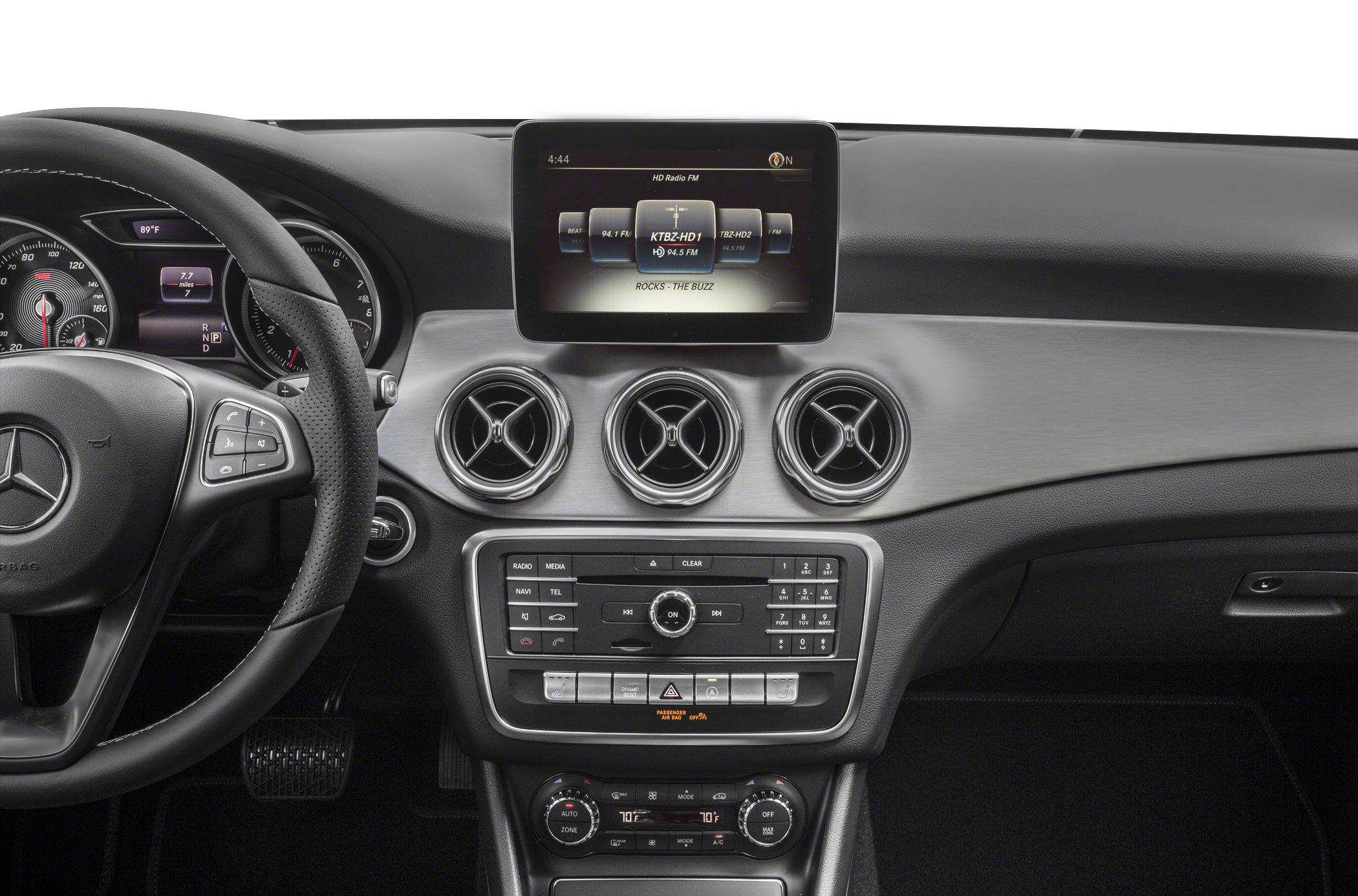 Steering wheel, round air vents, infotainment screen, and control panel