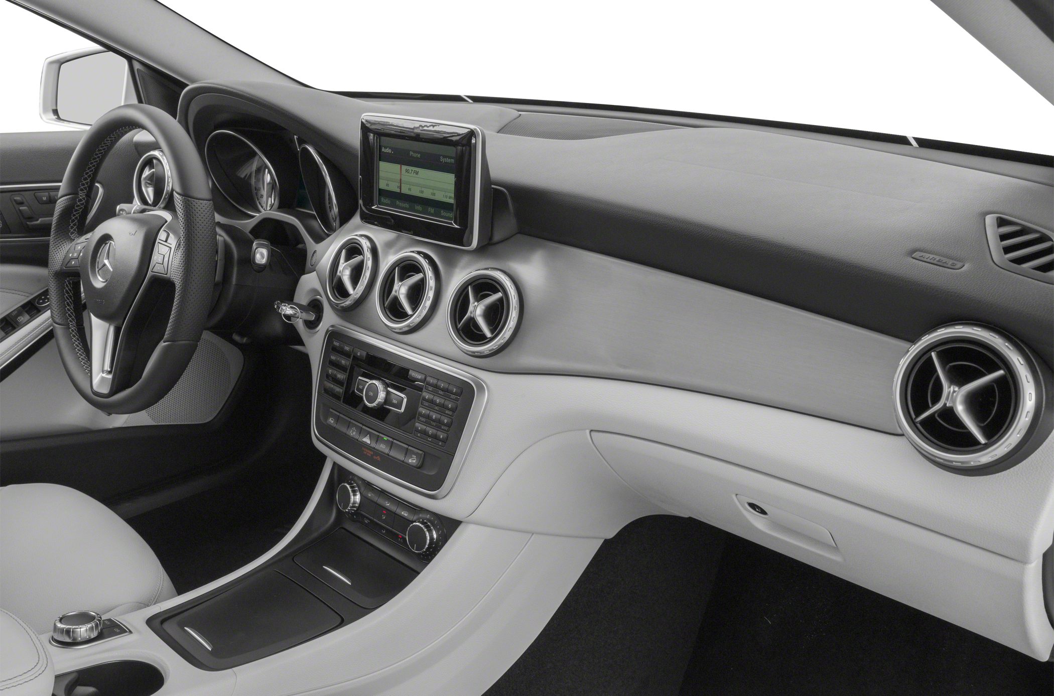 Dashboard with round vents, infotainment screen, and steering wheel