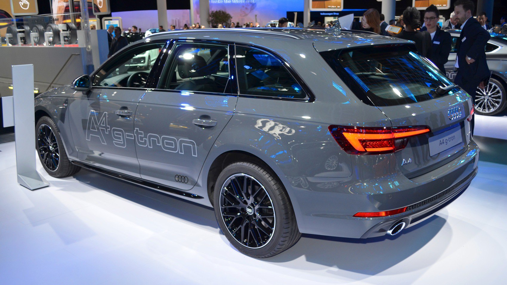 Rear-side view of a station wagon with black alloy wheels and A4 g-tron decal