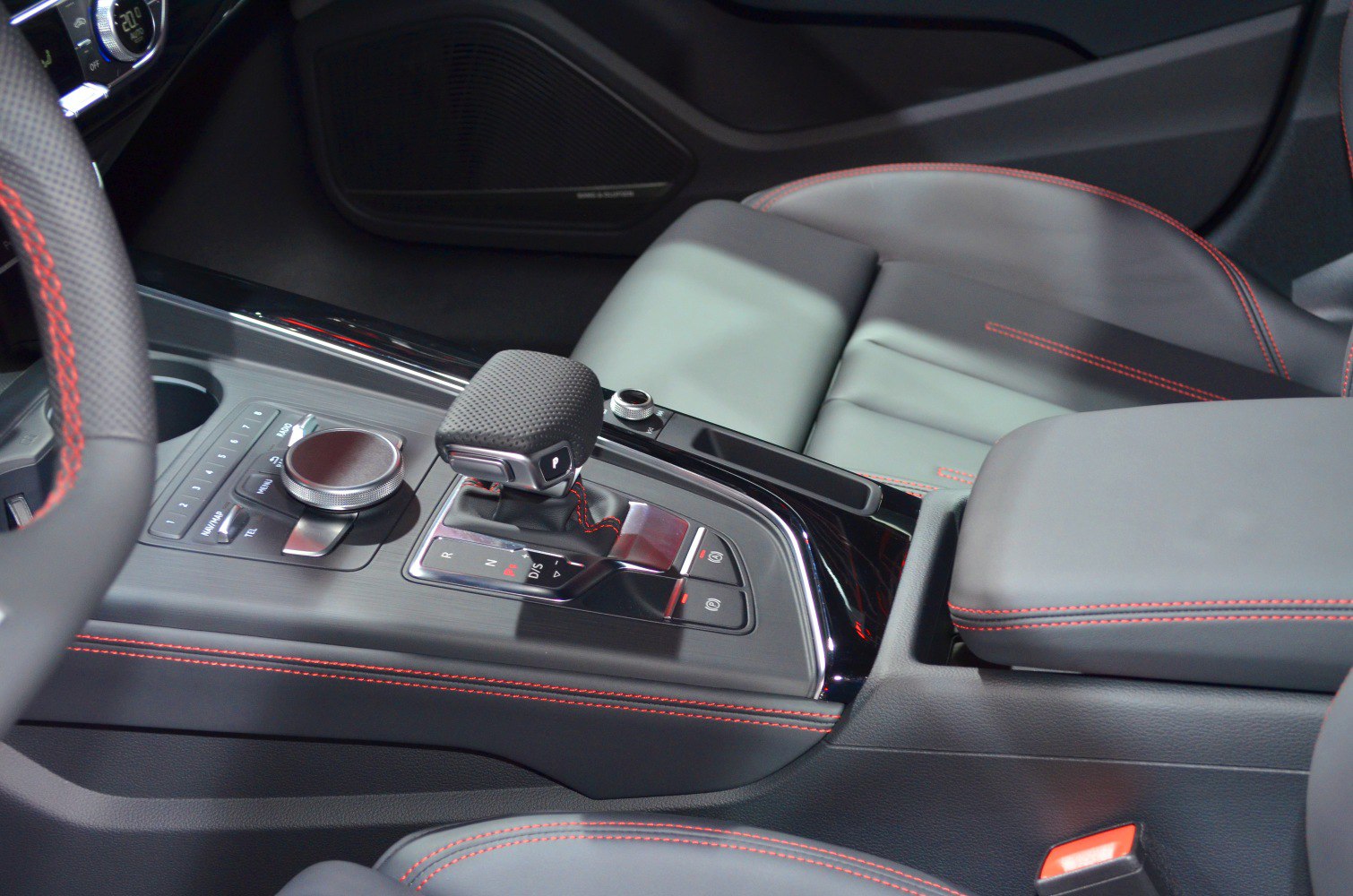 Automatic gear shift and armrest with red stitching