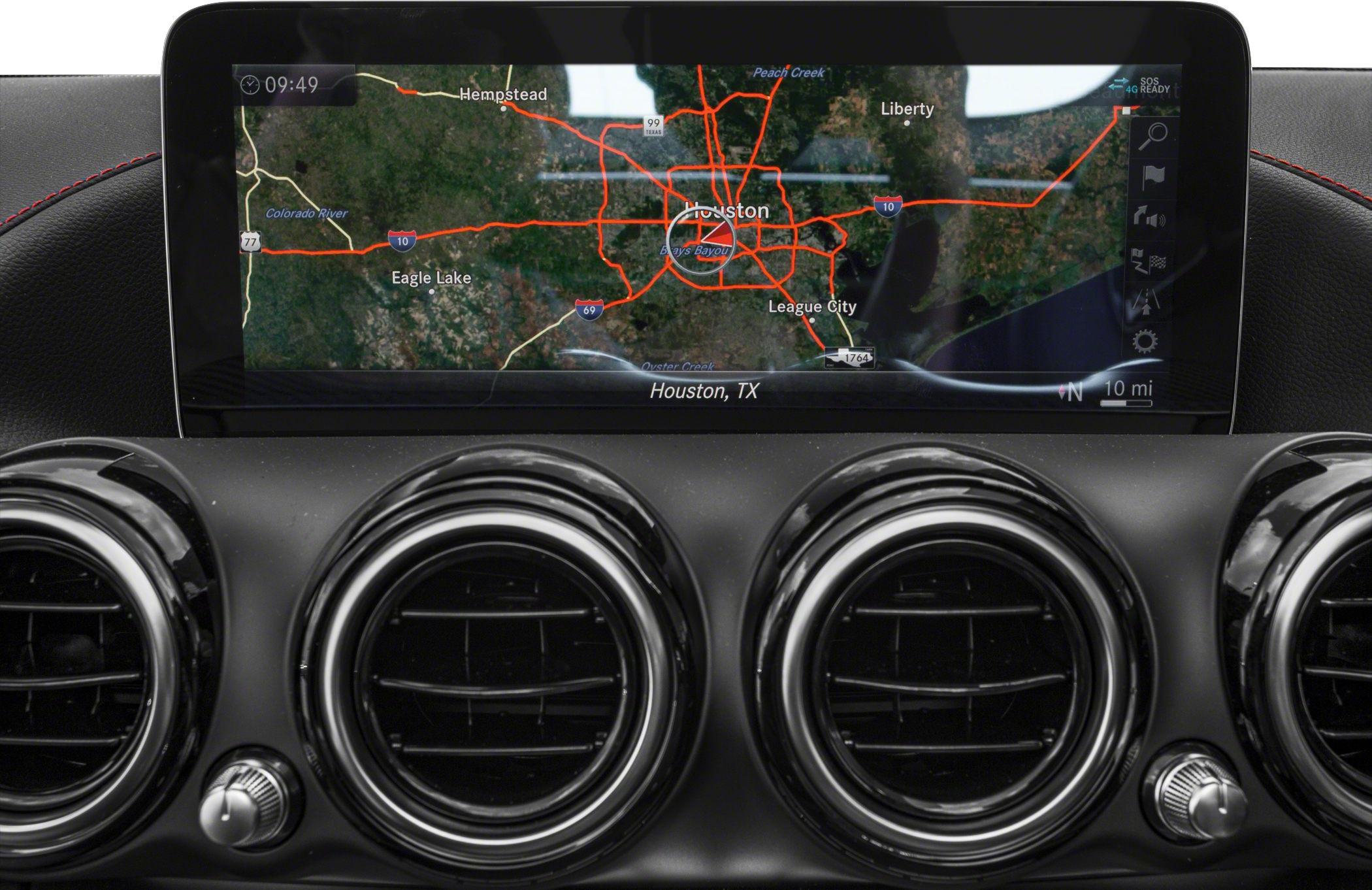 Navigation screen and circular air vents on car dashboard