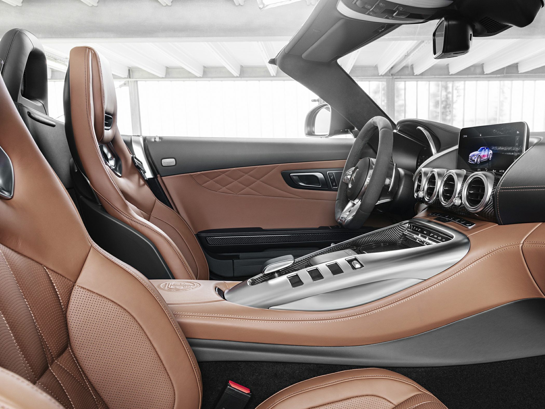 Luxurious brown leather seats, sporty steering wheel, advanced infotainment console