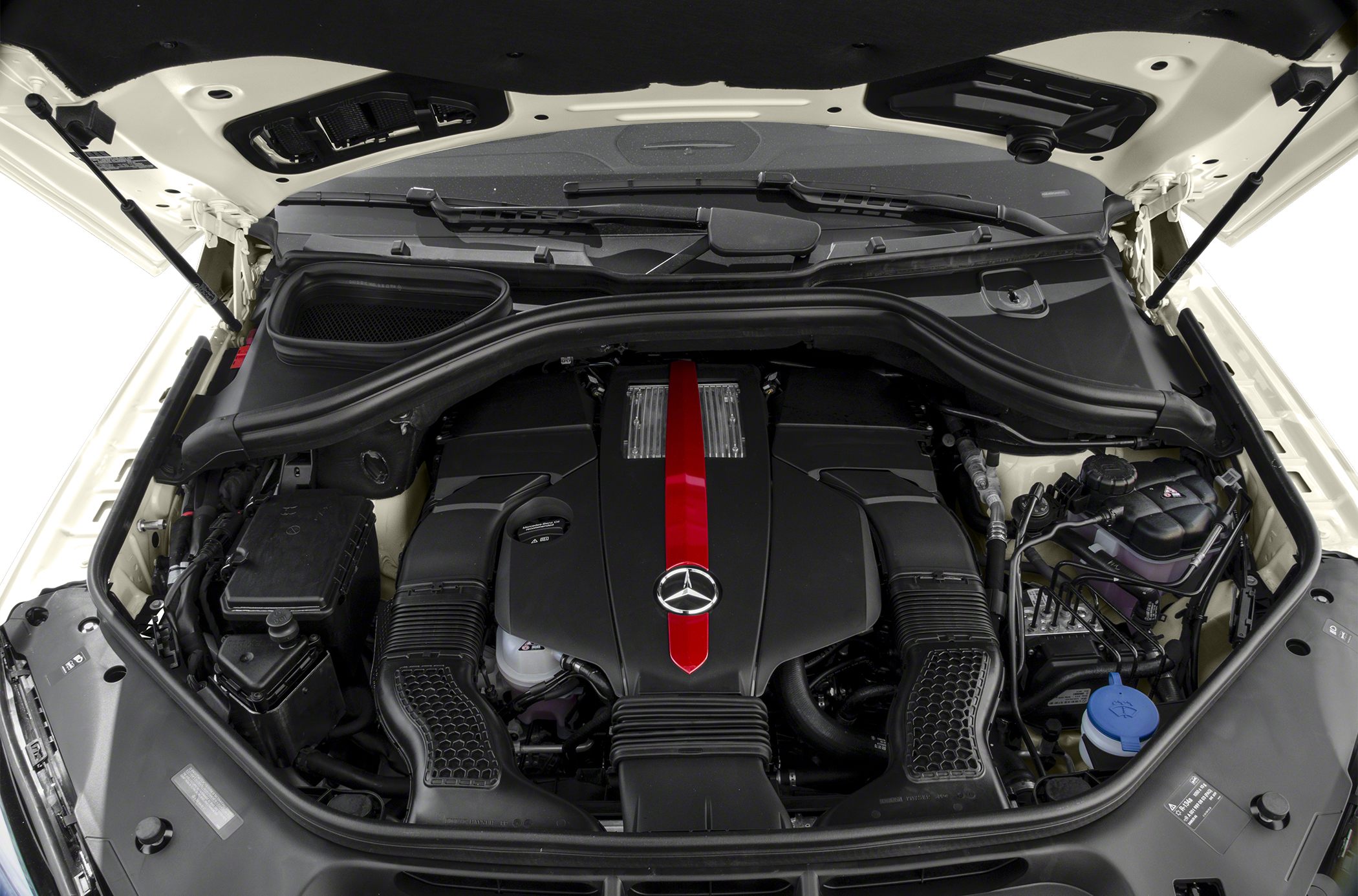 Engine bay with intake ducts and fluid reservoirs under open hood