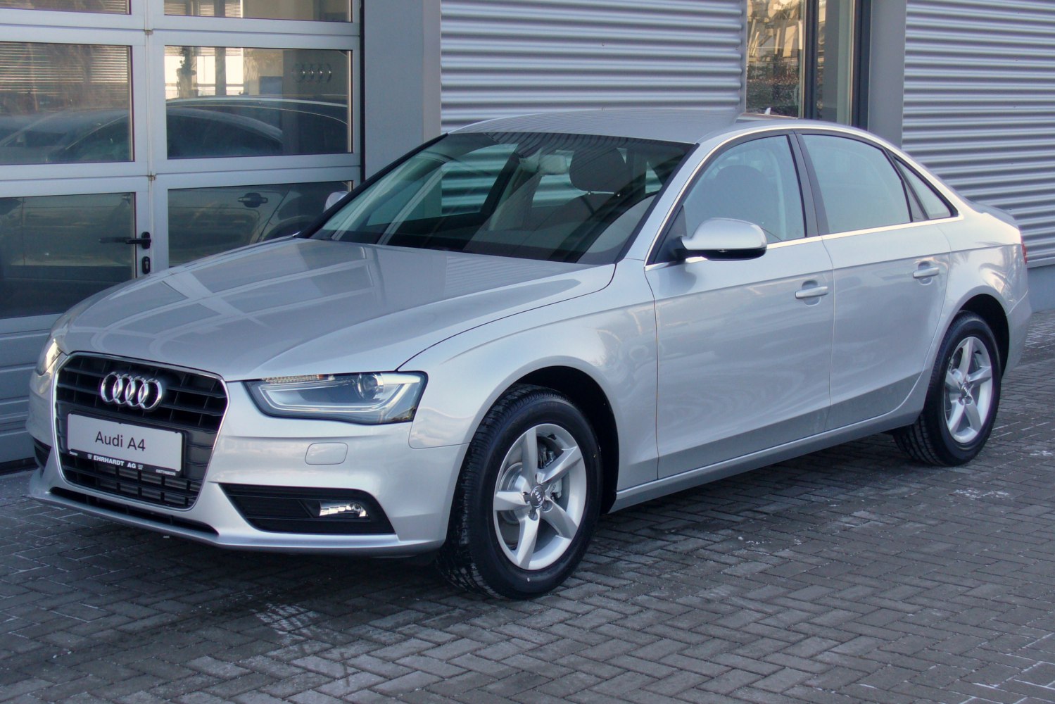 Silver sedan with modern headlight, grille, and alloy wheels.