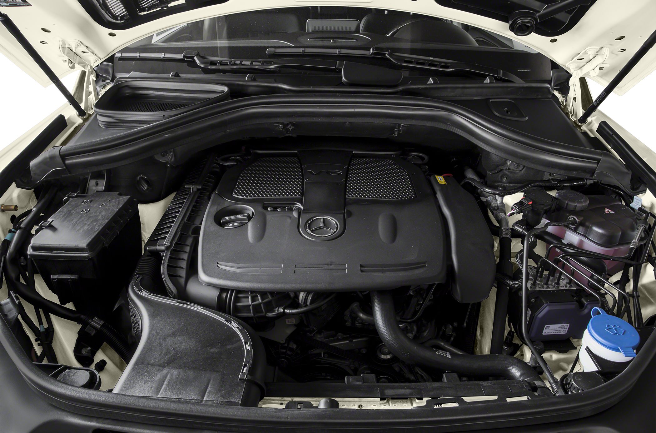 SUV engine bay with prominent V6 engine cover and Mercedes logo