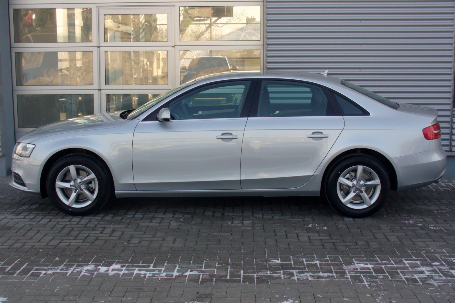 Side profile of silver mid-size sedan with alloy wheels