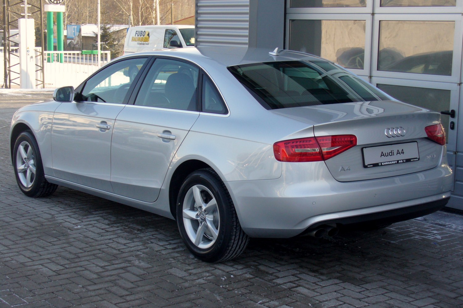 Silver Audi A4 B8 facelift sedan rear side view with distinct taillights and alloy wheels