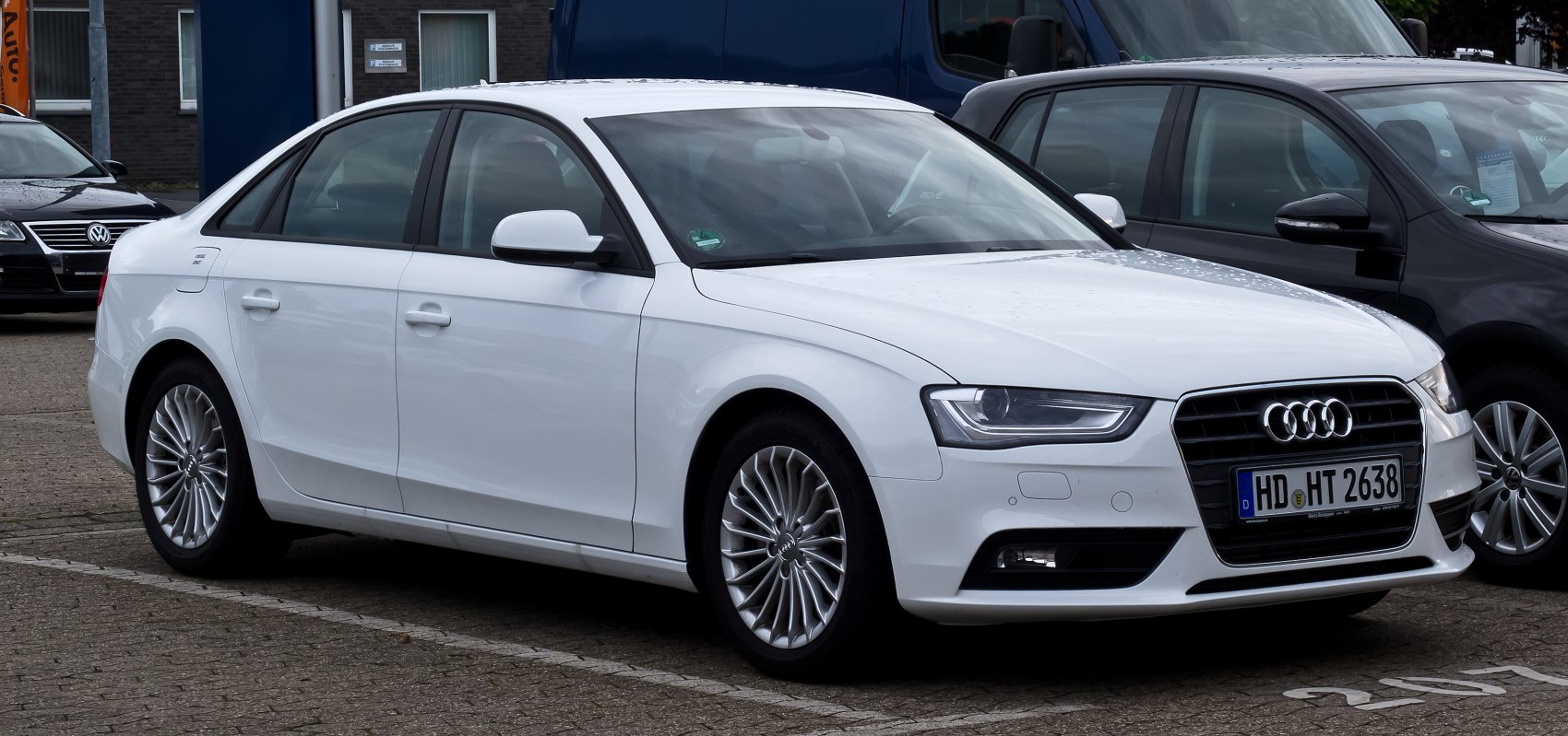 White sedan with LED headlights and multi-spoke alloy wheels from front side