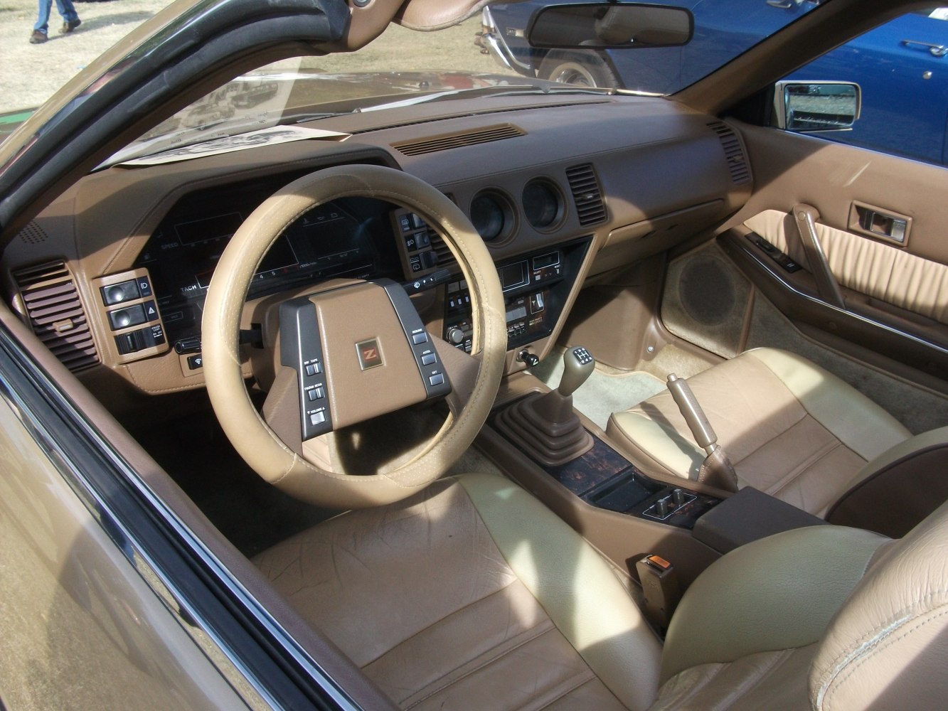 Beige leather interior with manual transmission and classic dashboard design