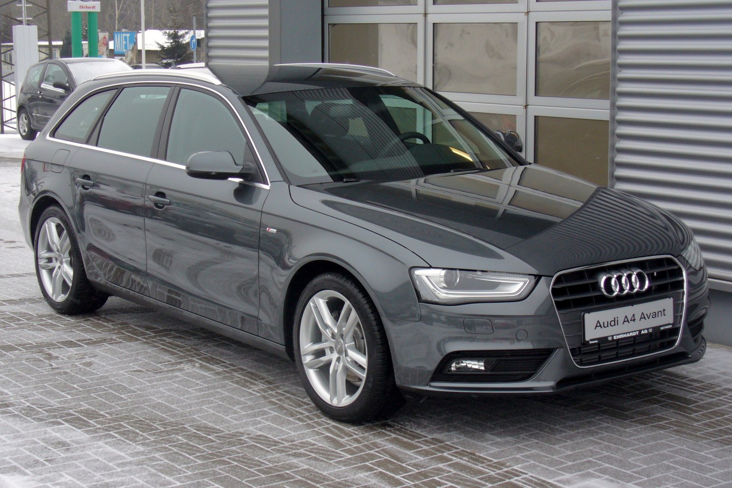 Front side view of sleek station wagon with LED headlights.