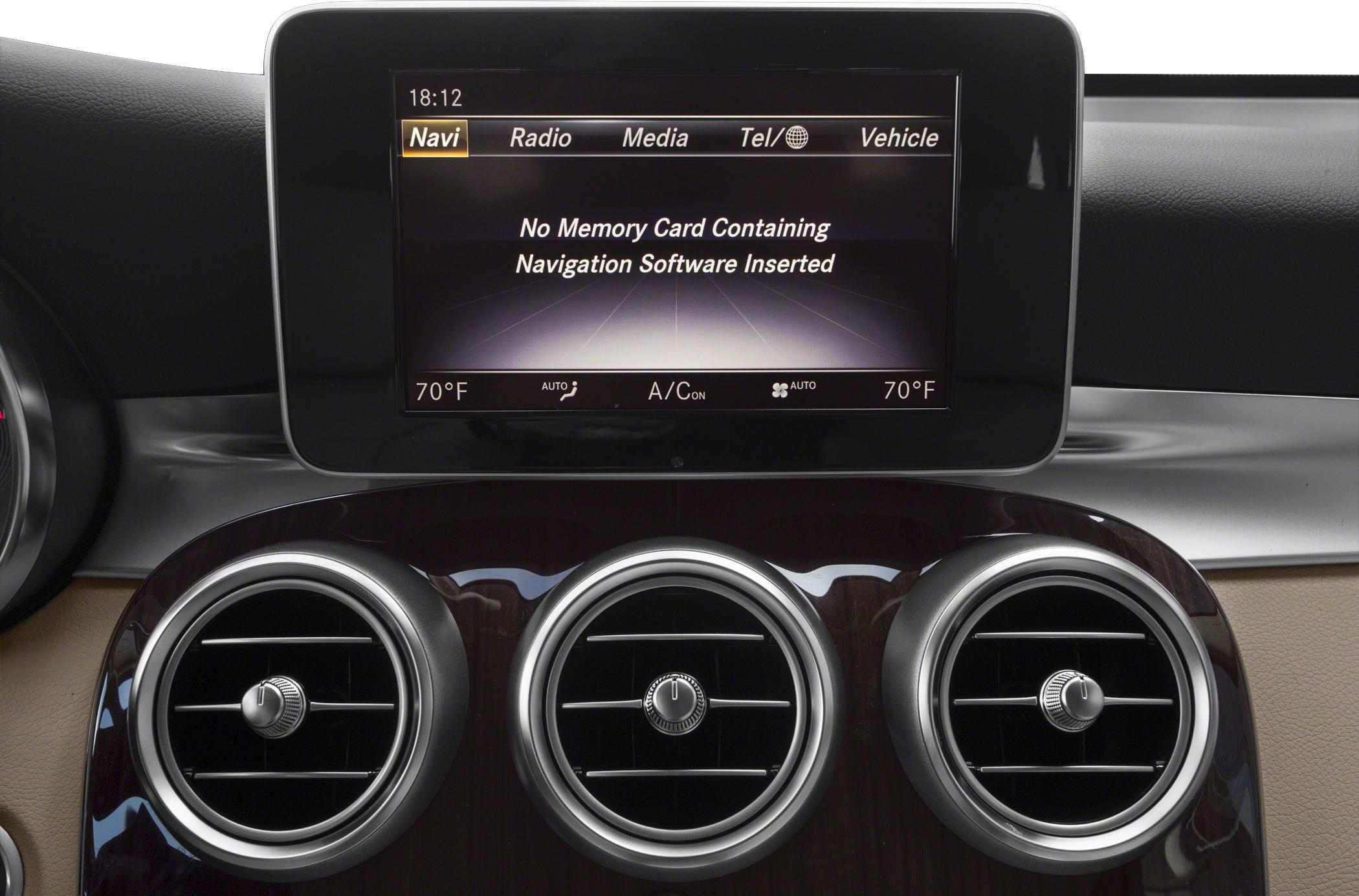Car interior display screen with navigation message and three circular air vents.