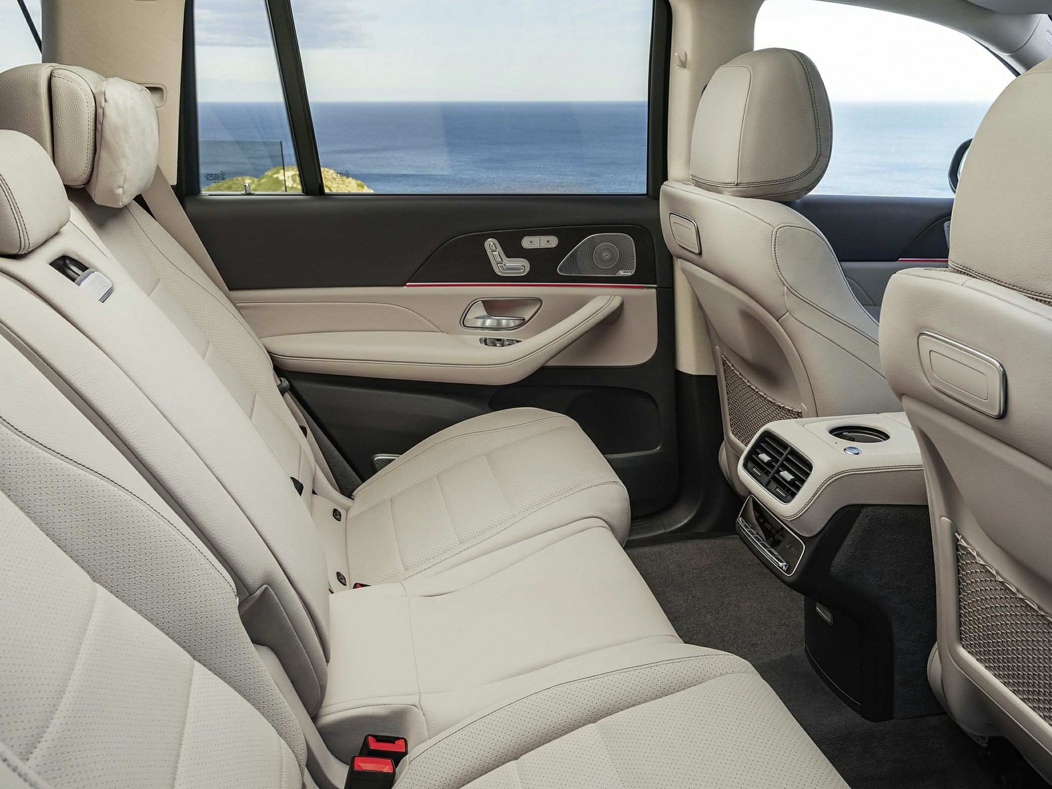 Rear seat interior with leather upholstery, ventilation, and luxury door controls