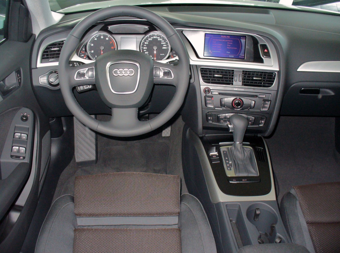 Dashboard, steering wheel, and center console with multimedia display