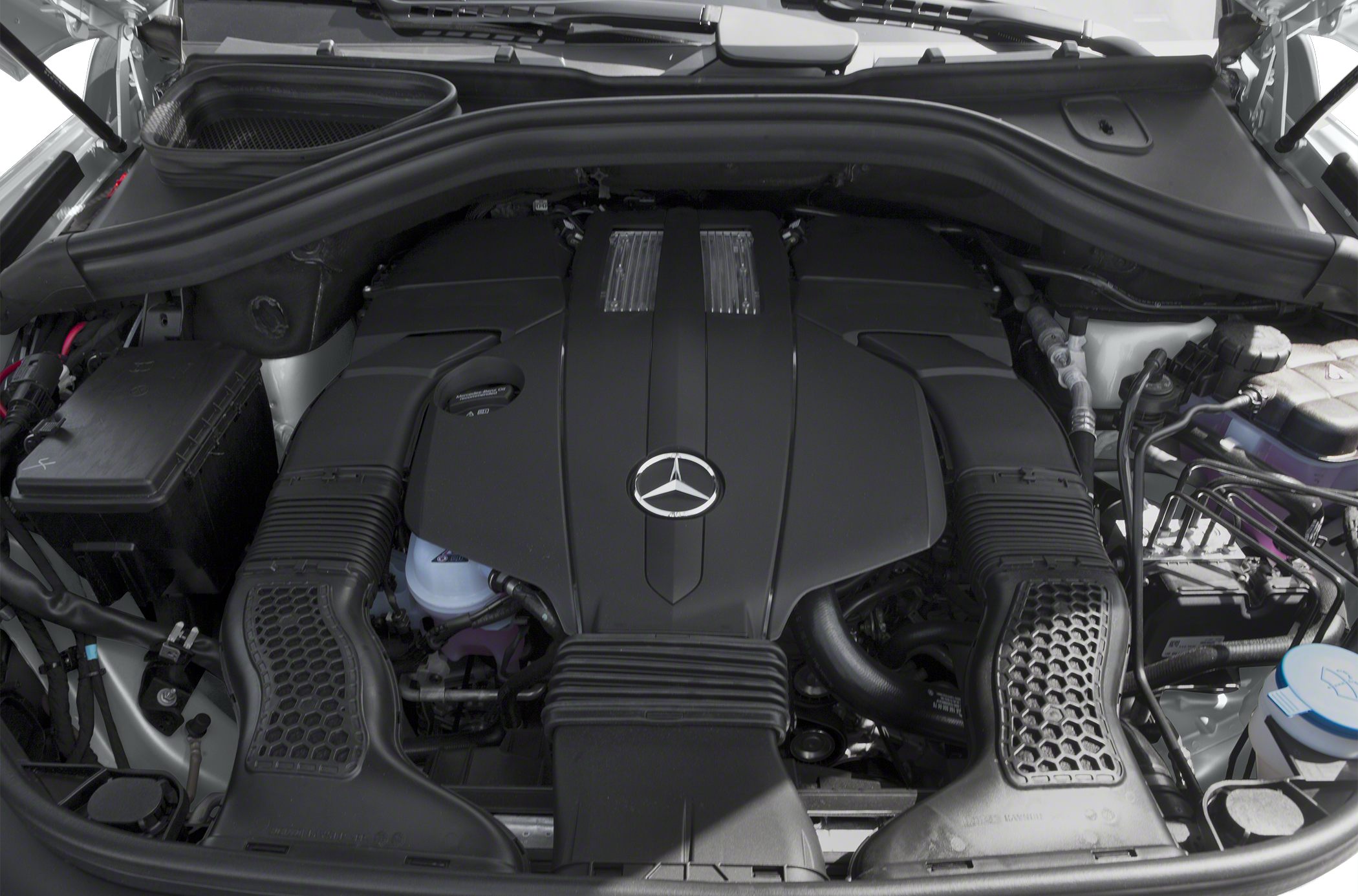 Engine bay with prominent engine cover and Mercedes emblem
