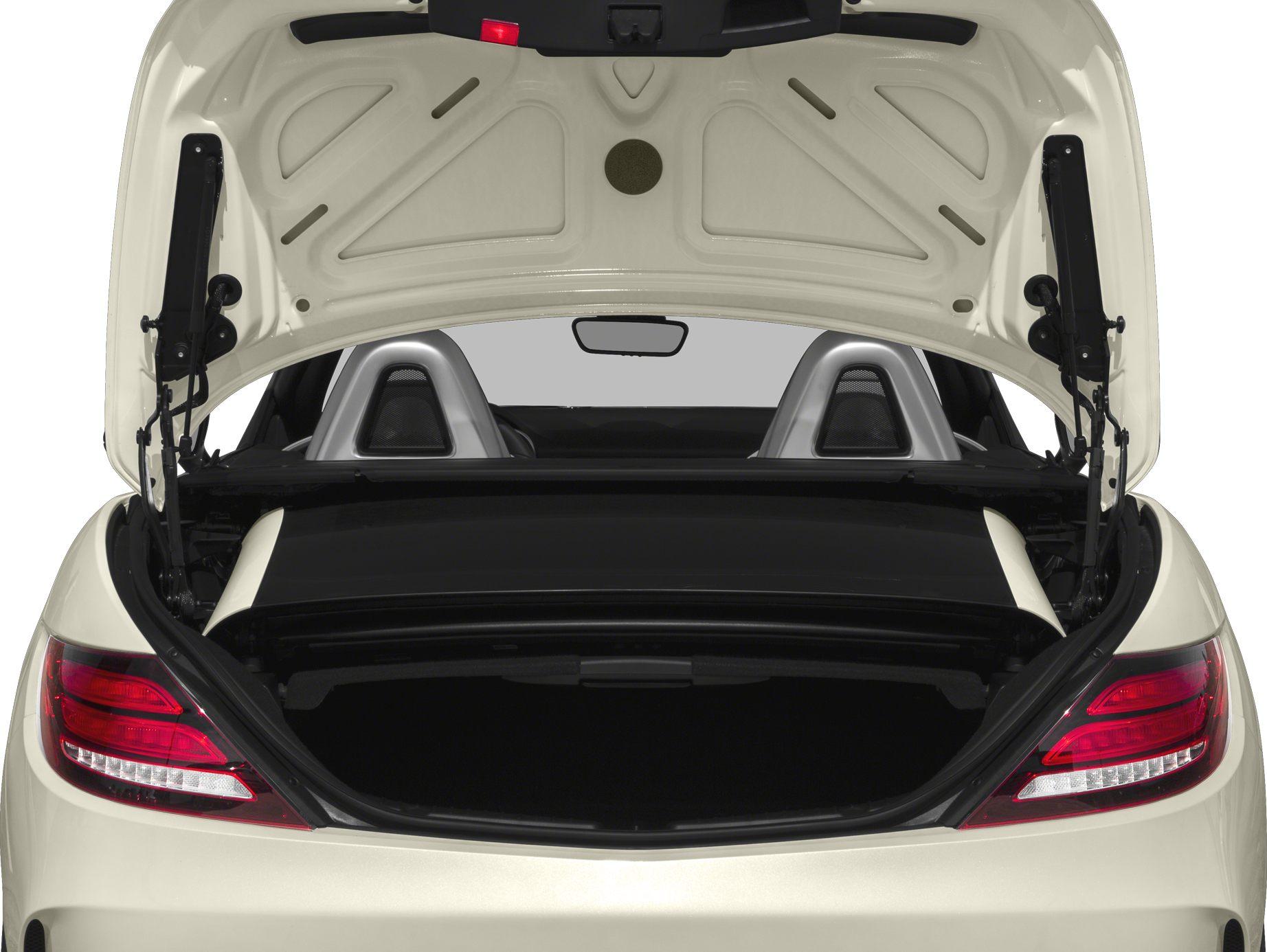 Open trunk with convertible roof mechanism and rear seats headrests