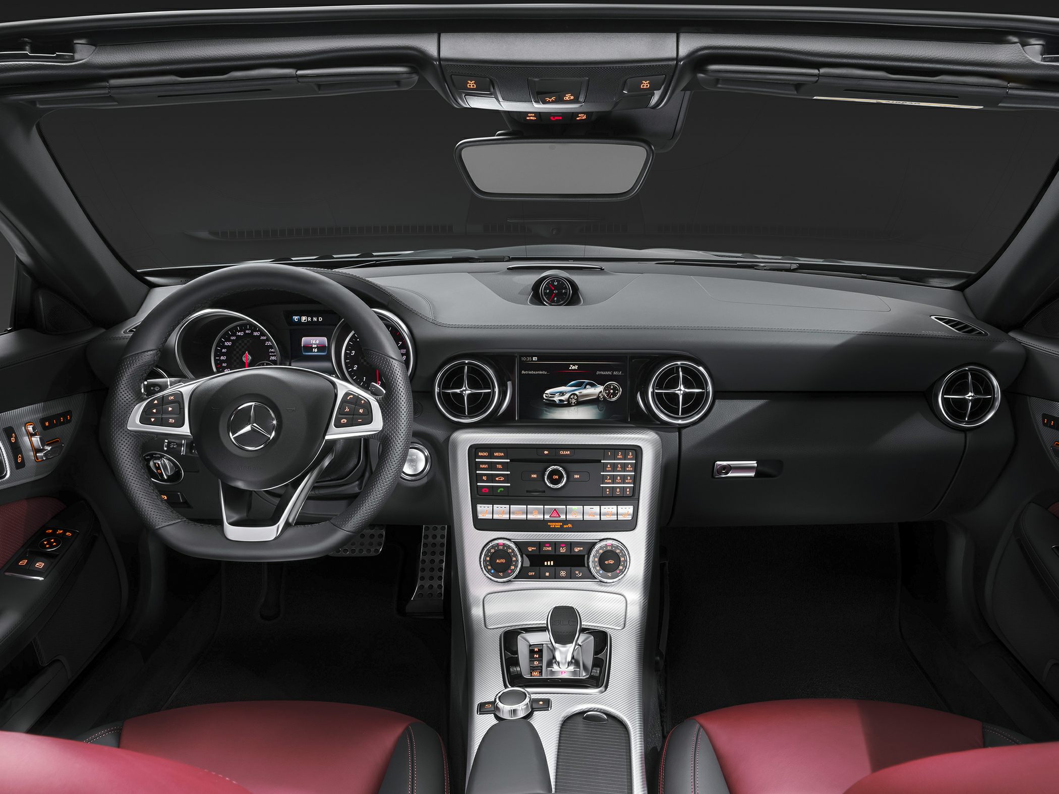 Modern luxury car interior with multifunction steering wheel and center console controls