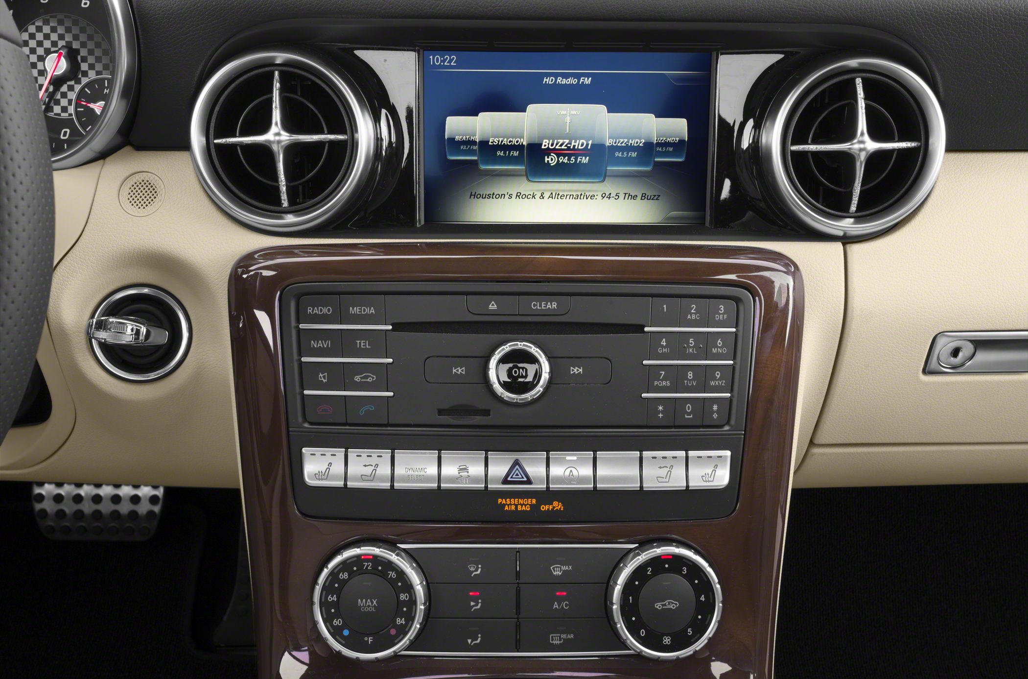 Dashboard multimedia system and circular air vents in beige interior