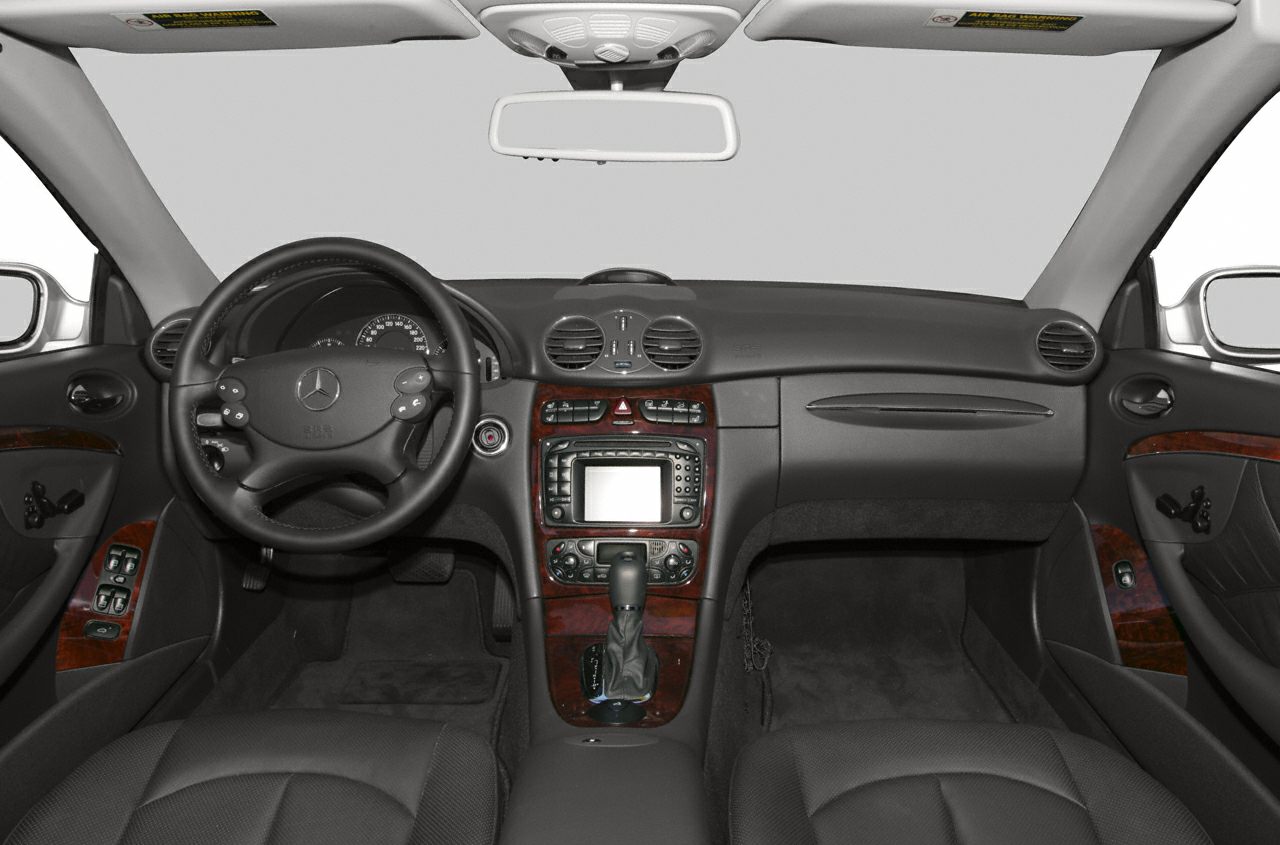 Luxury car interior dashboard with wood trim and navigation display