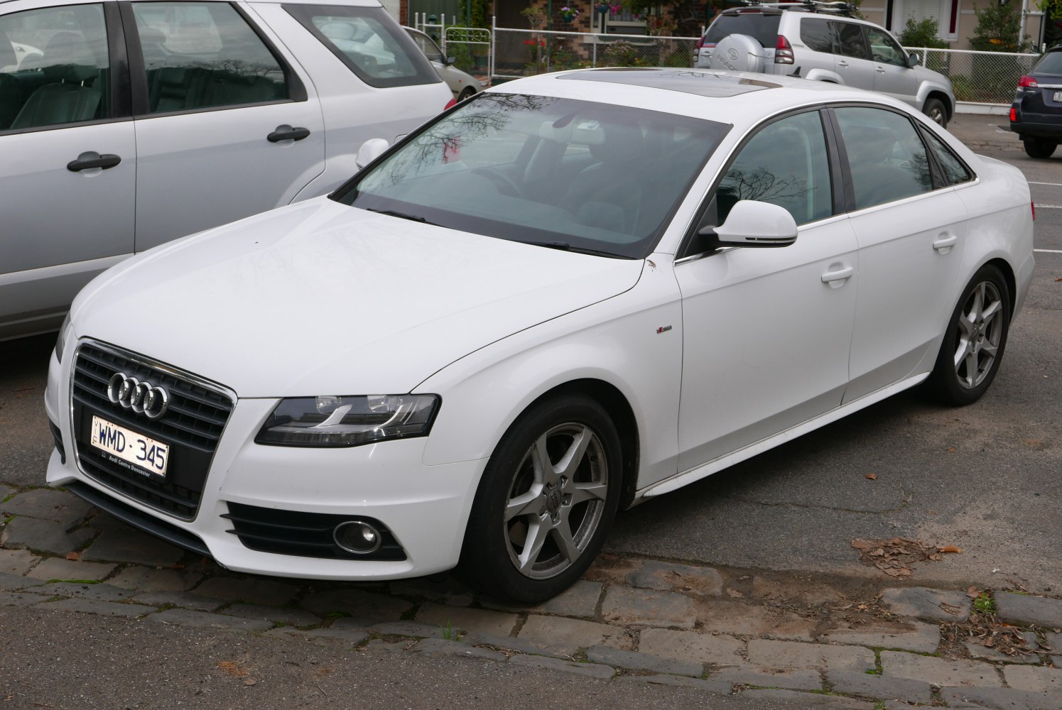 White sedan with sunroof and alloy wheels