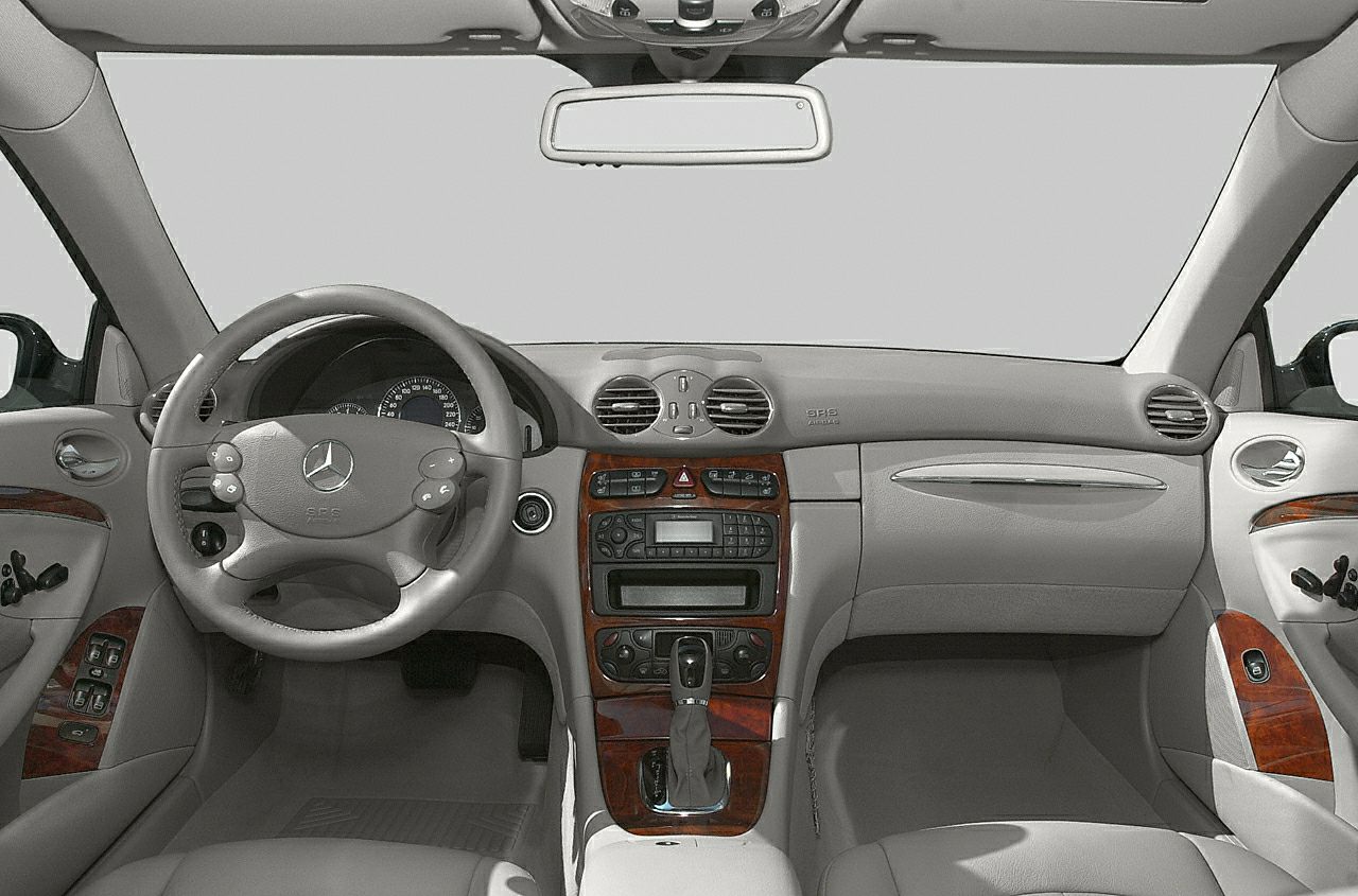 Dashboard, steering wheel with controls, wood trim interior